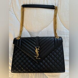 YSL shoulder bag in chevron/ diamond-quilted black leather. Gold Hardware